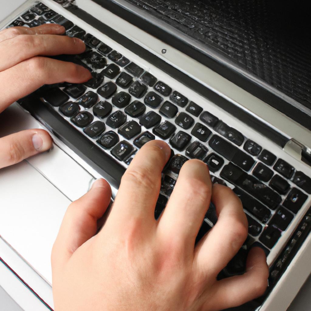 Person typing on laptop computer